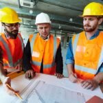 Modern architects looking at sketch of construction